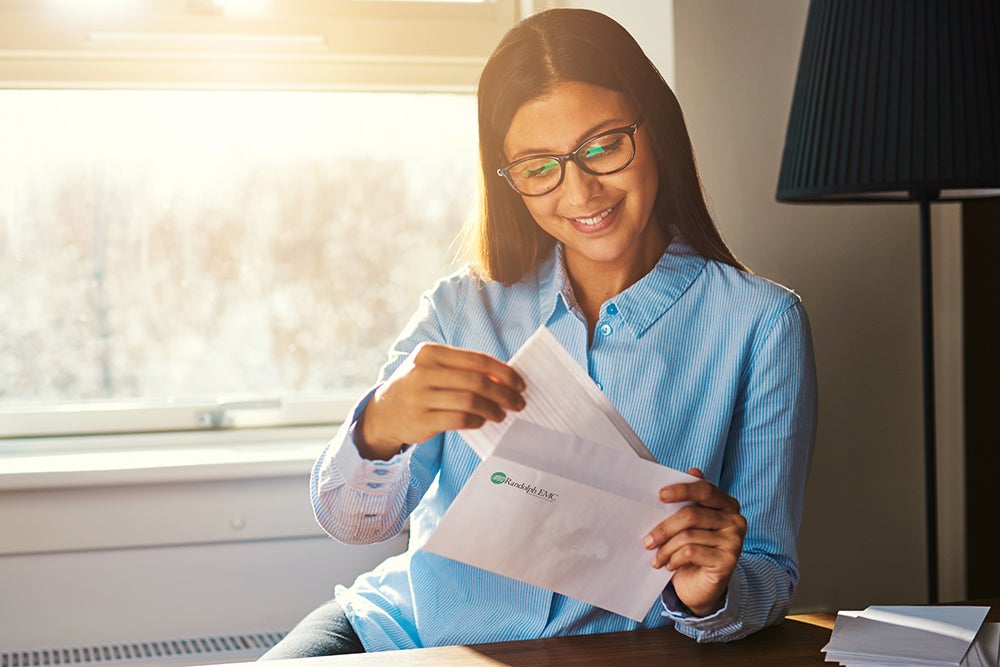woman opens mail from REMC