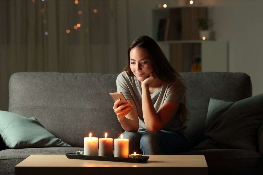 woman looking at candles in the dark