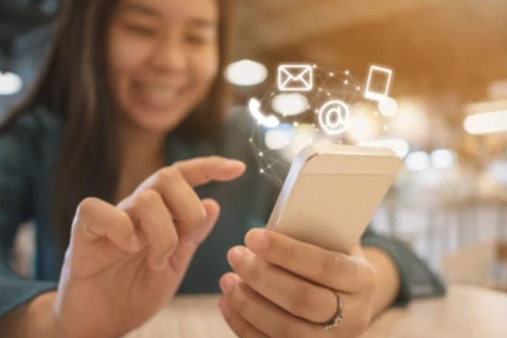 woman with contact info icons showing above phone