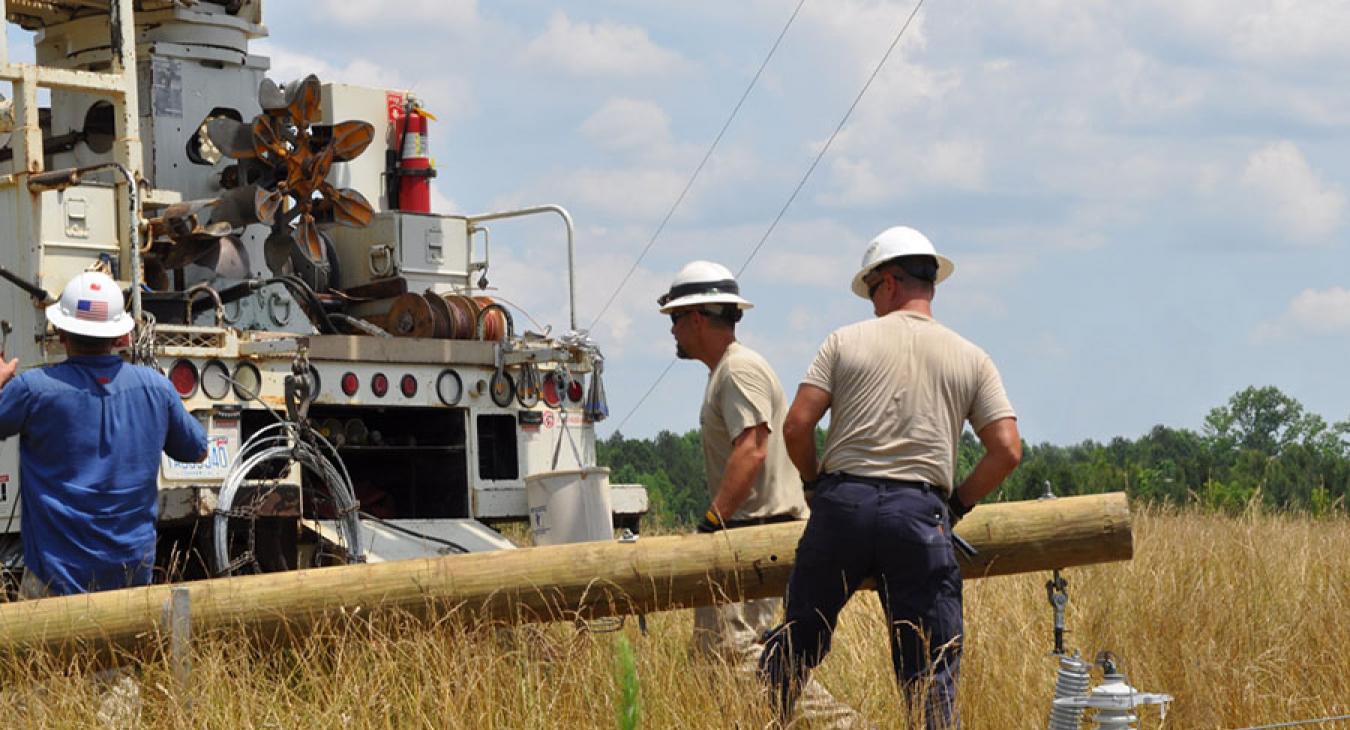Lineworkers in a field