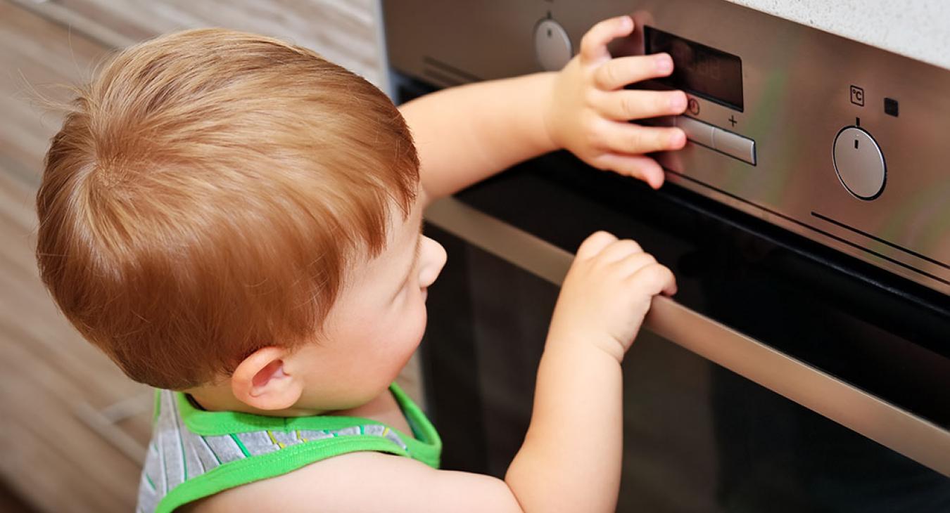 Baby touching stove